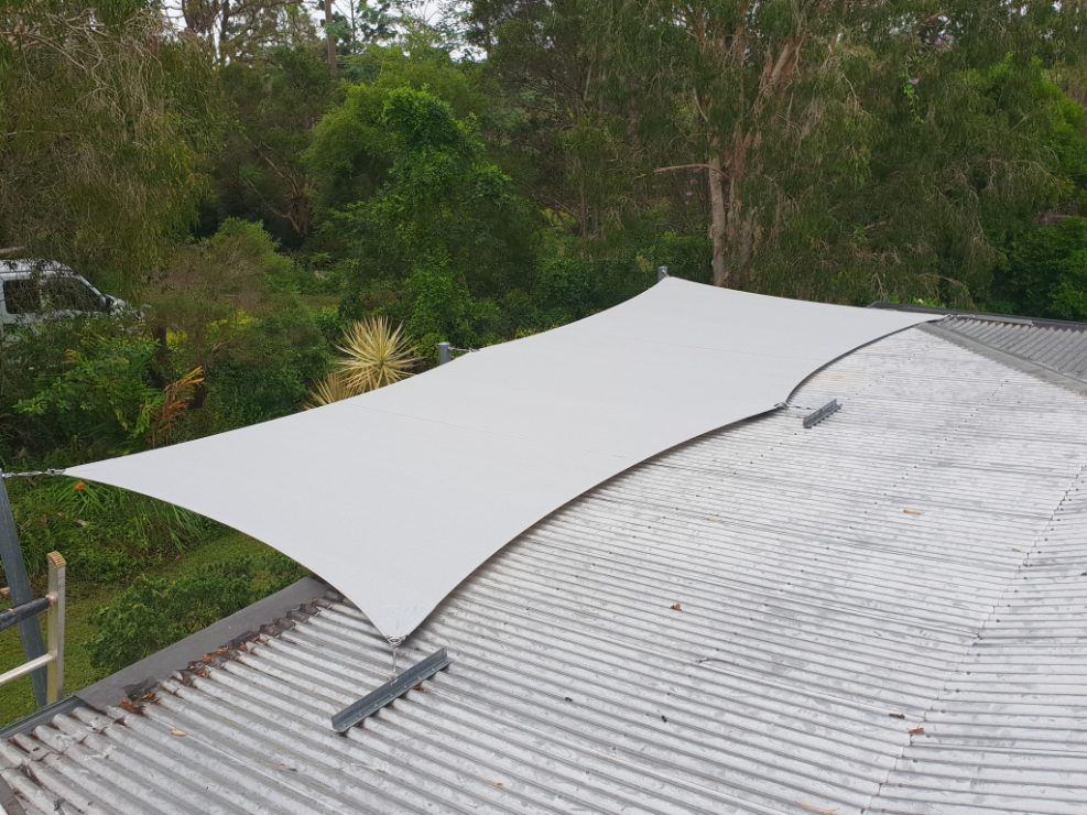 A Large White Umbrella is Sitting on Top of a Roof — Cooloola Sail Company In Cooloola Cove, QLD