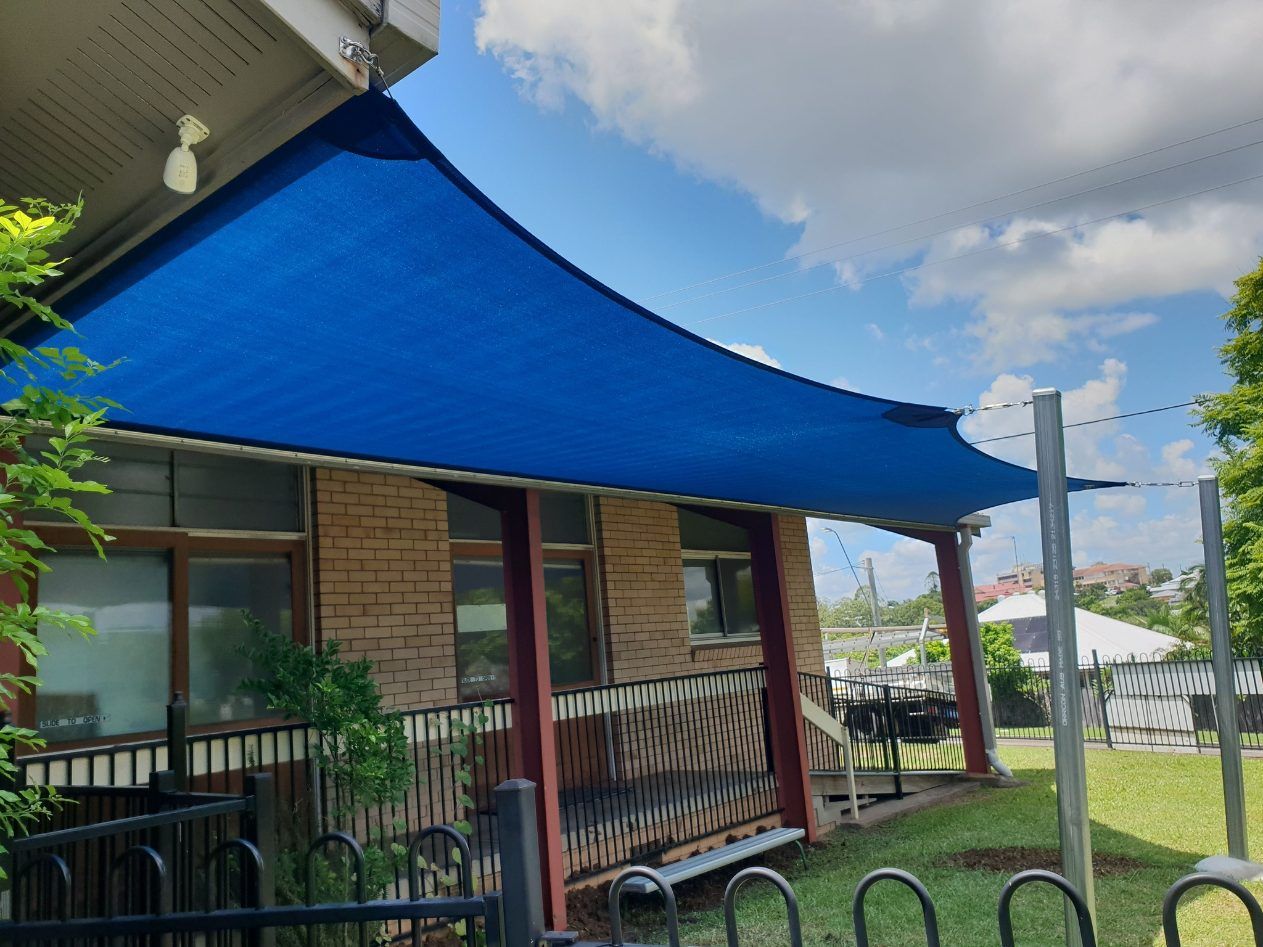A Blue Shade Sail is Covering a Porch of a House — Cooloola Sail Company In Cooroy, QLD