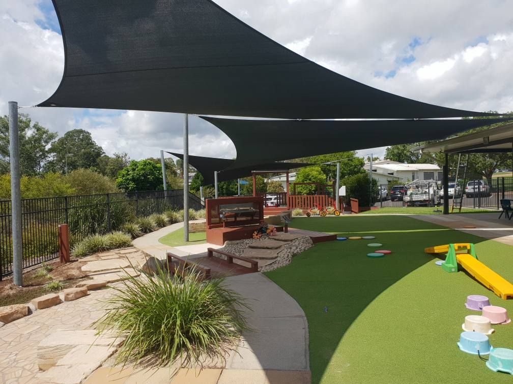 A Fenced in Area With a Pool and Mountains in the Background — Cooloola Sail Company In Southside, QLD