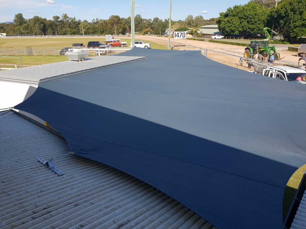 A Large Blue Umbrella is Sitting on Top of a Roof — Cooloola Sail Company In Tamaree, QLD