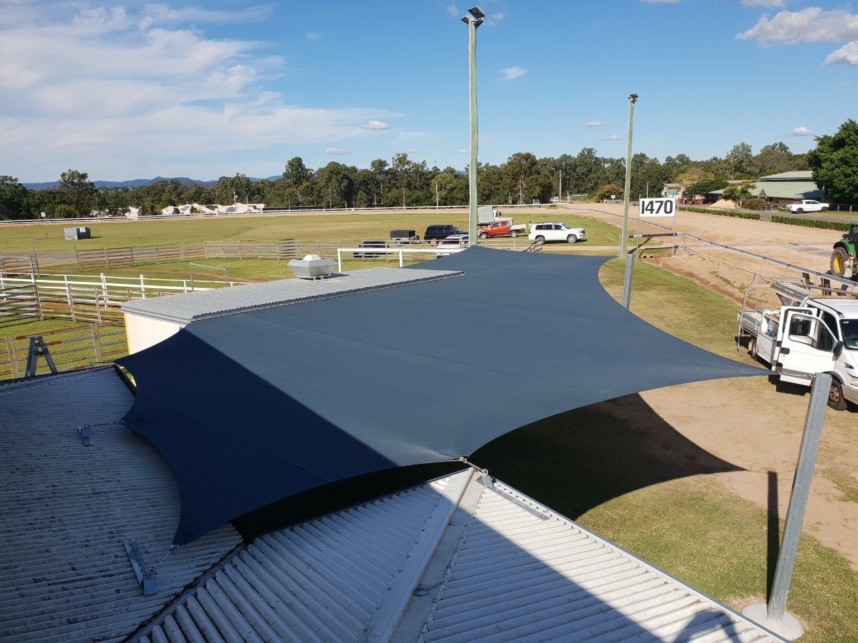 A Large Umbrella is Sitting on Top of a Building — Cooloola Sail Company In Rainbow Beach, QLD