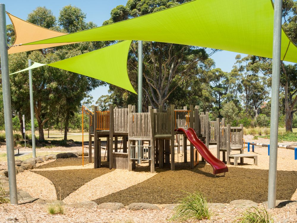 A Playground With a Slide Under a Green Umbrella — Cooloola Sail Company In Southside, QLD
