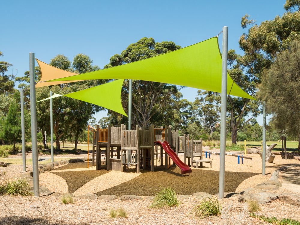 A Playground With a Slide Under a Green Umbrella — Cooloola Sail Company In Tamaree, QLD