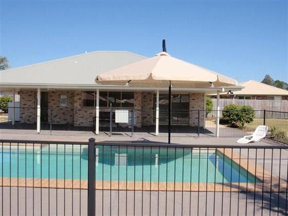 A House With a Swimming Pool in Front of It — Cooloola Sail Company In Southside, QLD