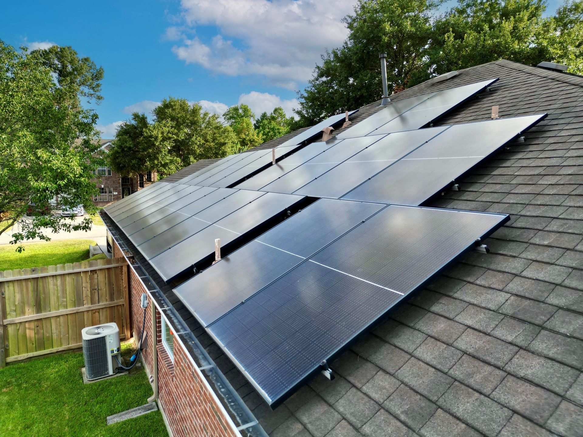 Solar panels installed on a residential roof, reflecting the sky.