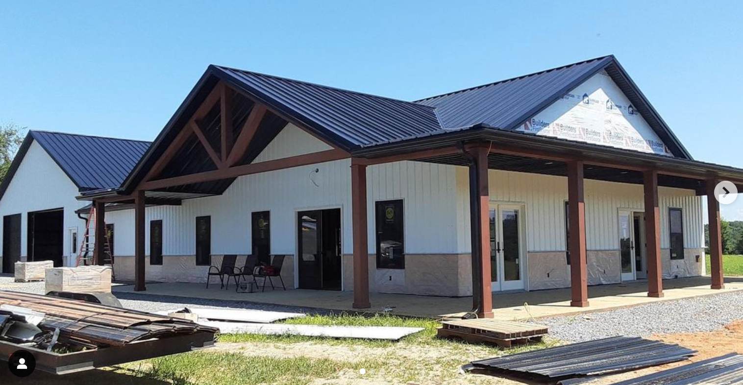 Barndominium with stone and metal siding a metal roof
