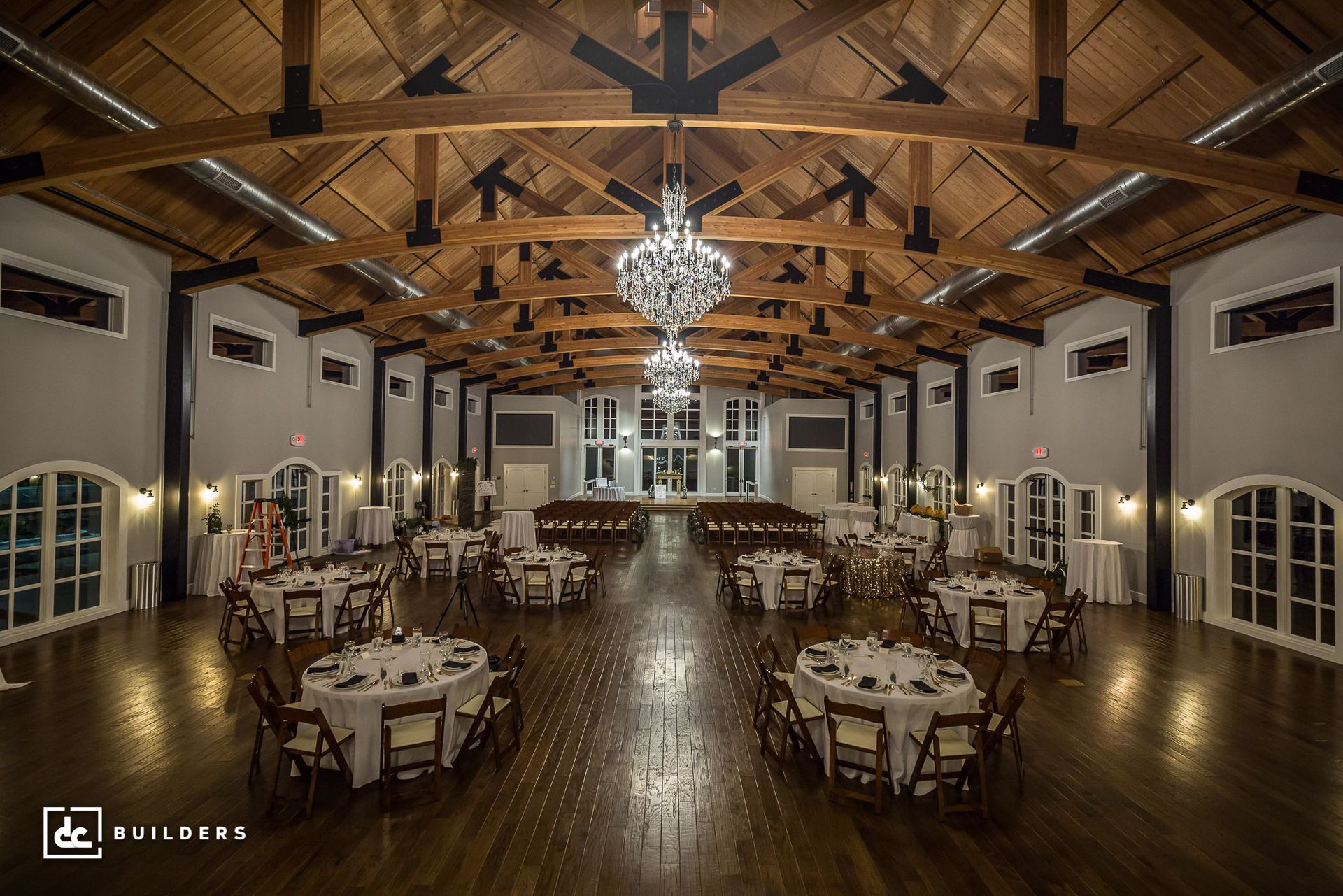 Large dining in hall with tall ceilings inside a barndominium event venue