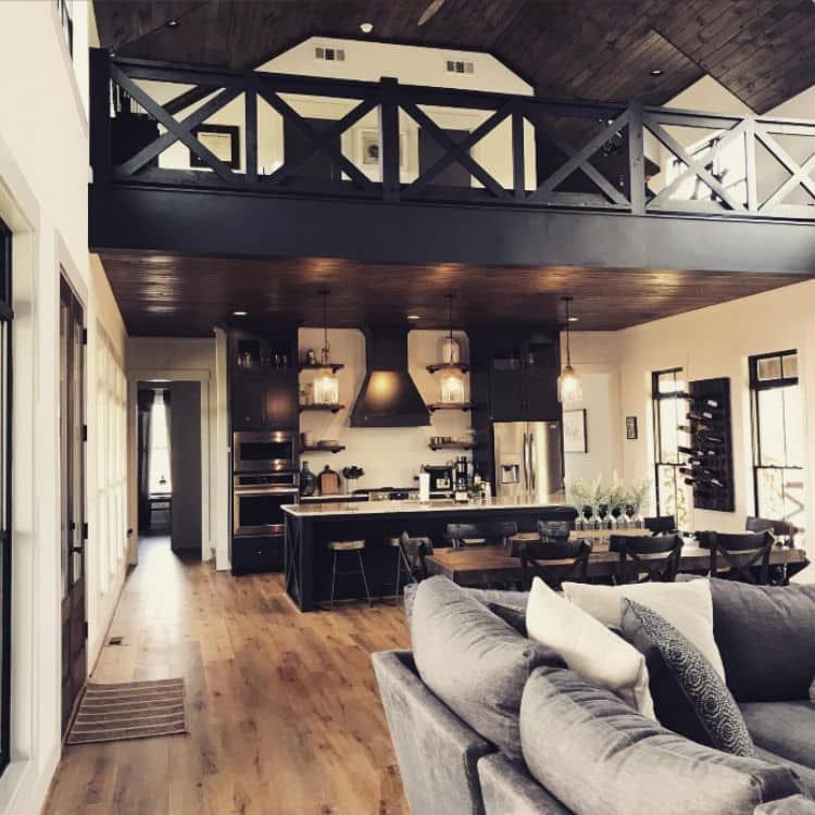 Loft over kithcen in modern barndominium showing kitchen and living room. 
