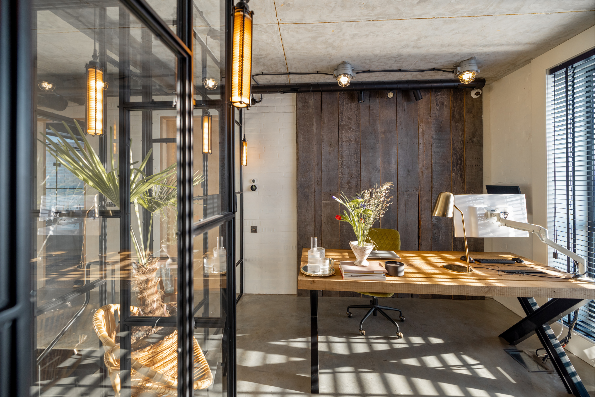 A modern office with a wooden desk and a computer on it.
