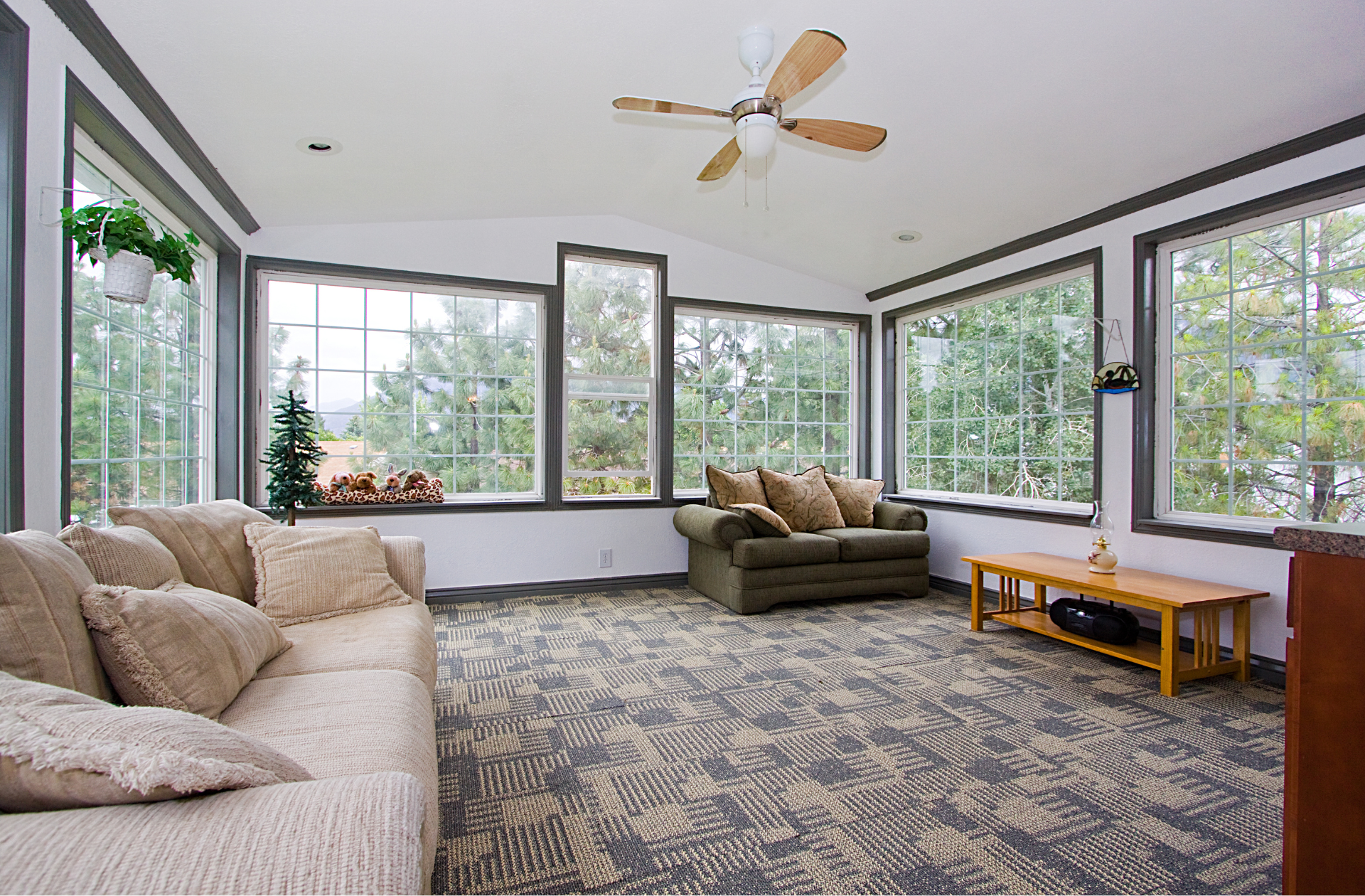 A living room with a couch and a ceiling fan