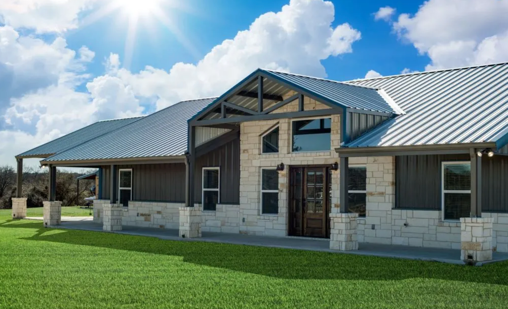 Stone and metal siding combination on a large luxury barndominium 