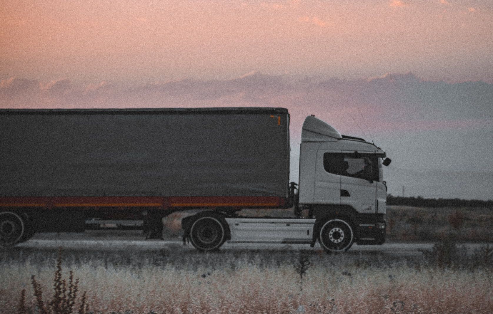 Get Started Large Freight truck delivering barndominium materials