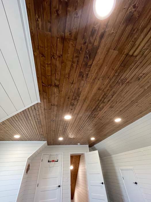 A room with a wooden ceiling and white walls.