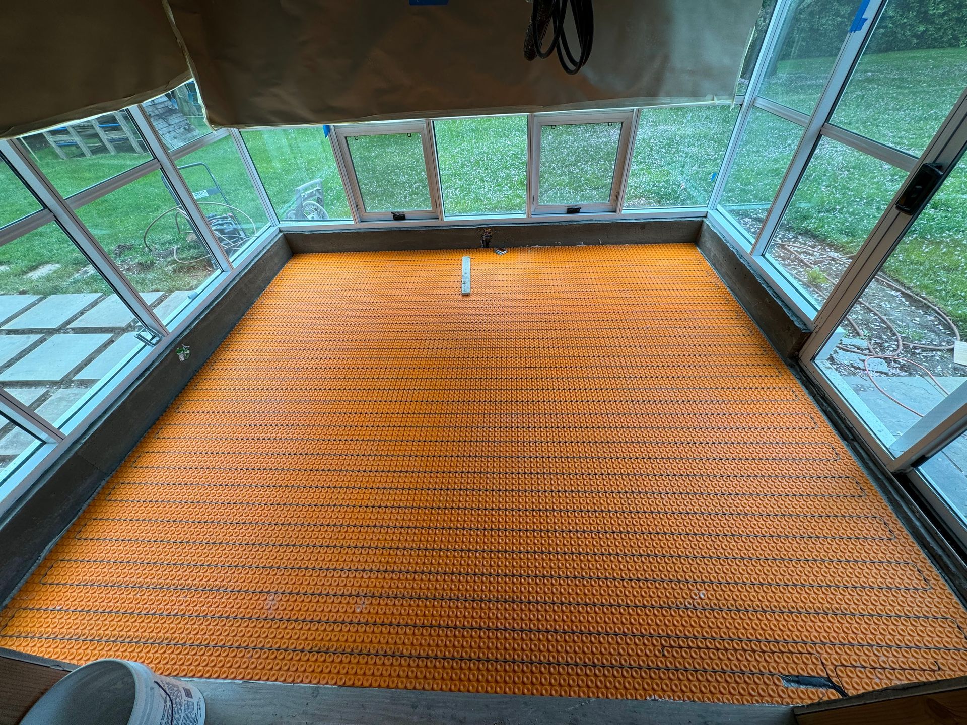 A New York house with a heated floor that is being installed by an Electrician