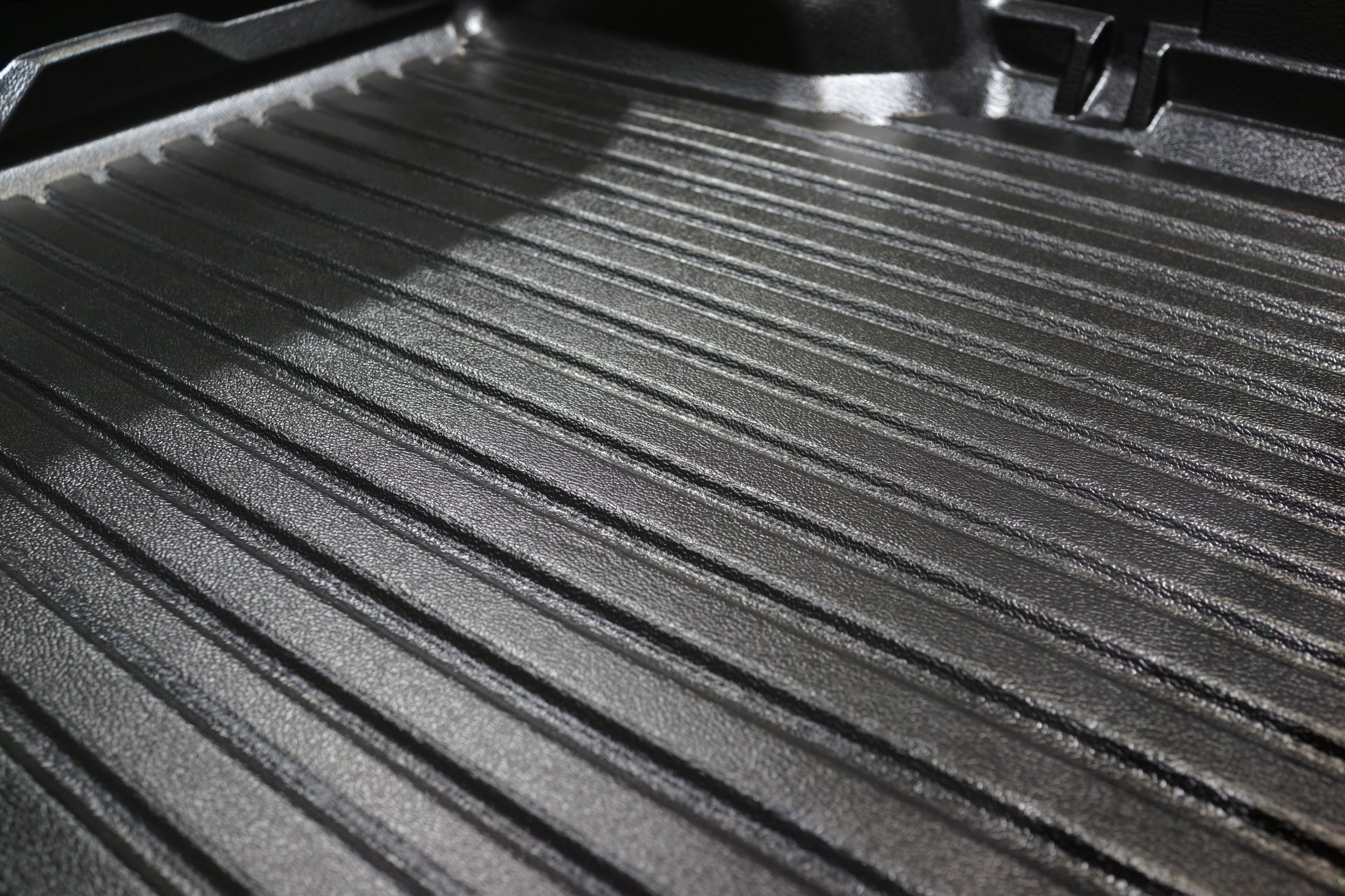 Black ridged truck bed liner with a textured, durable surface and raised sides