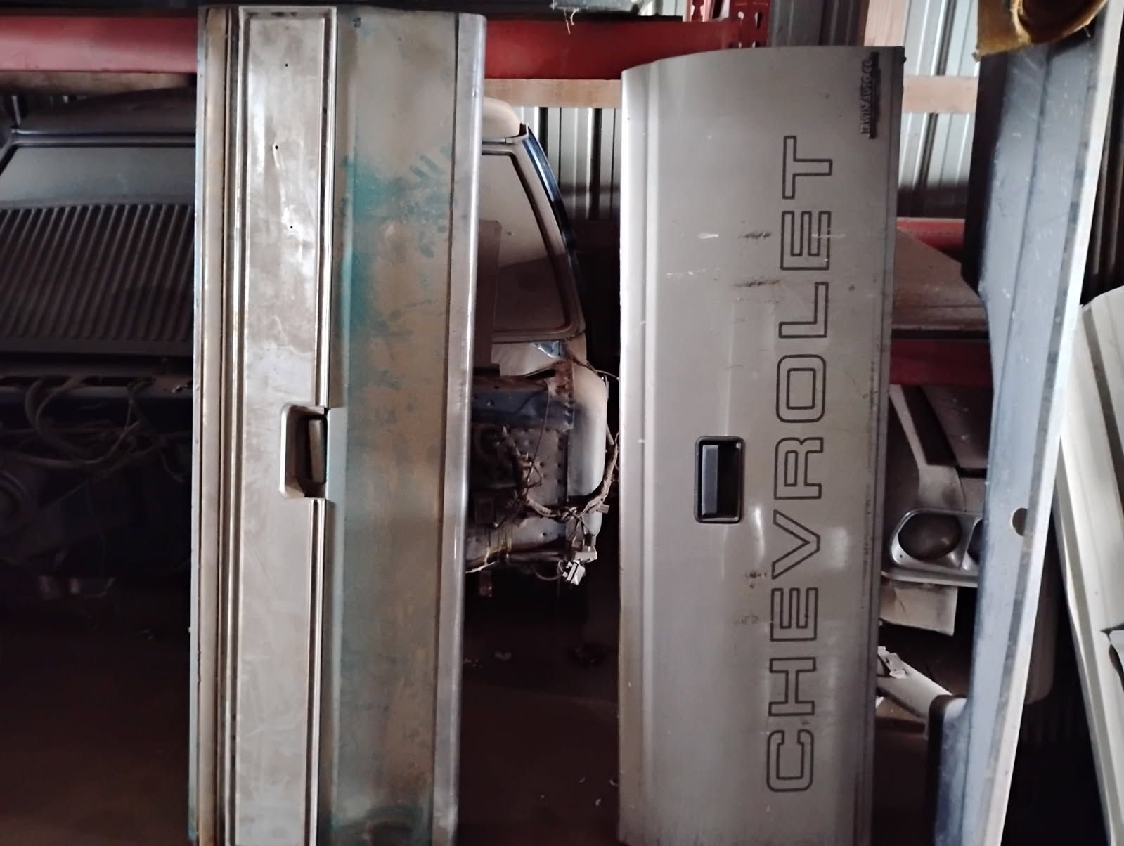 Person holding a car clutch pressure plate over a cardboard box in a workshop