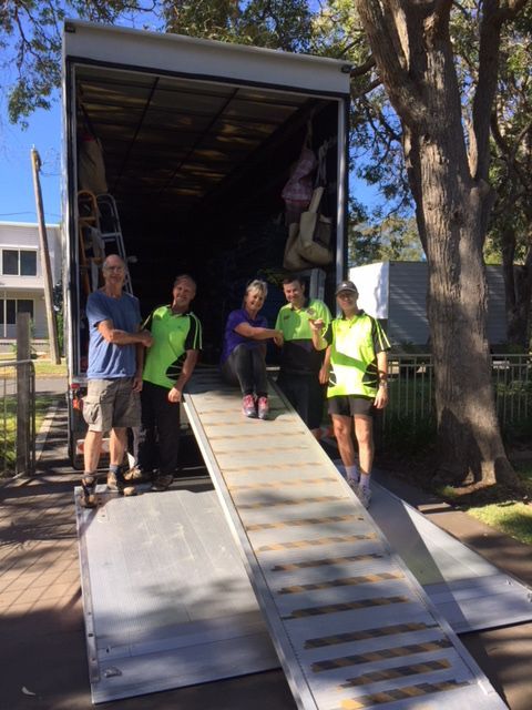 People Standing Out The Back Of A Removal Truck — Fairdinkum Removals In Nowra, NSW