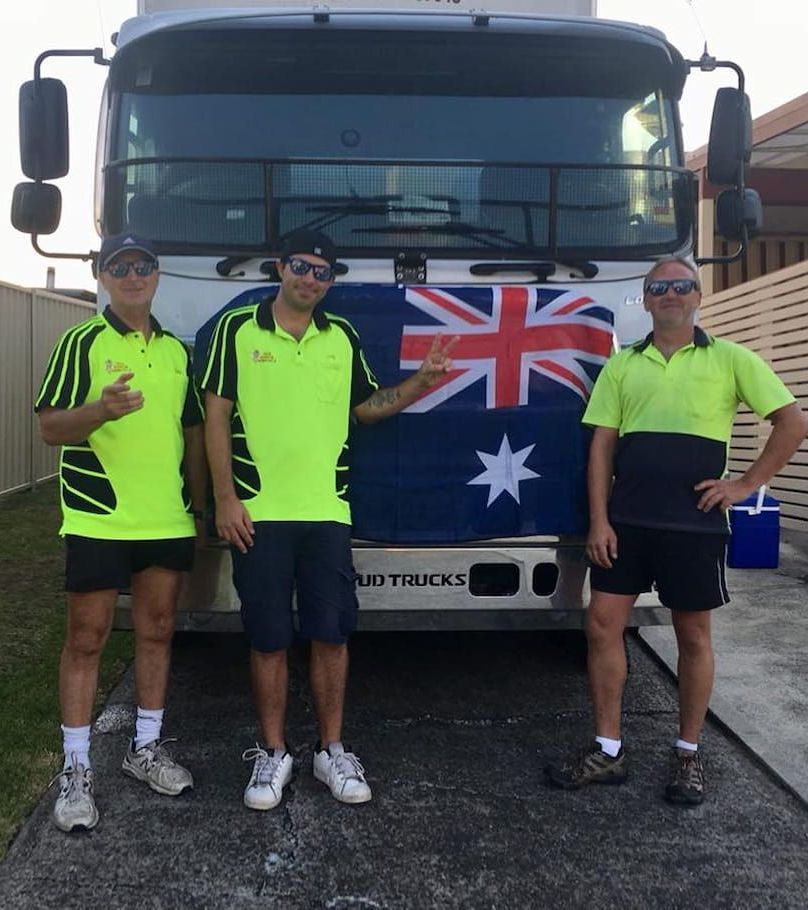 Three Men Standing In Front Of Moving Truck — Fairdinkum Removals In Jervis Bay, NSW