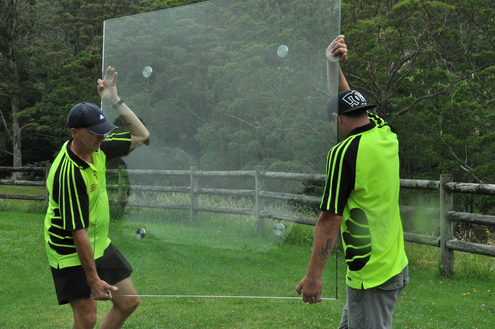 Two Men Are Carrying Glass Out Of A House — Fairdinkum Removals In Nowra, NSW