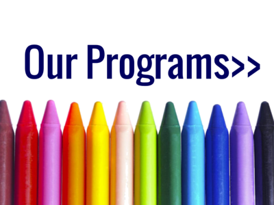 “Our Programs>>” text above a row of colorful crayons on a white background