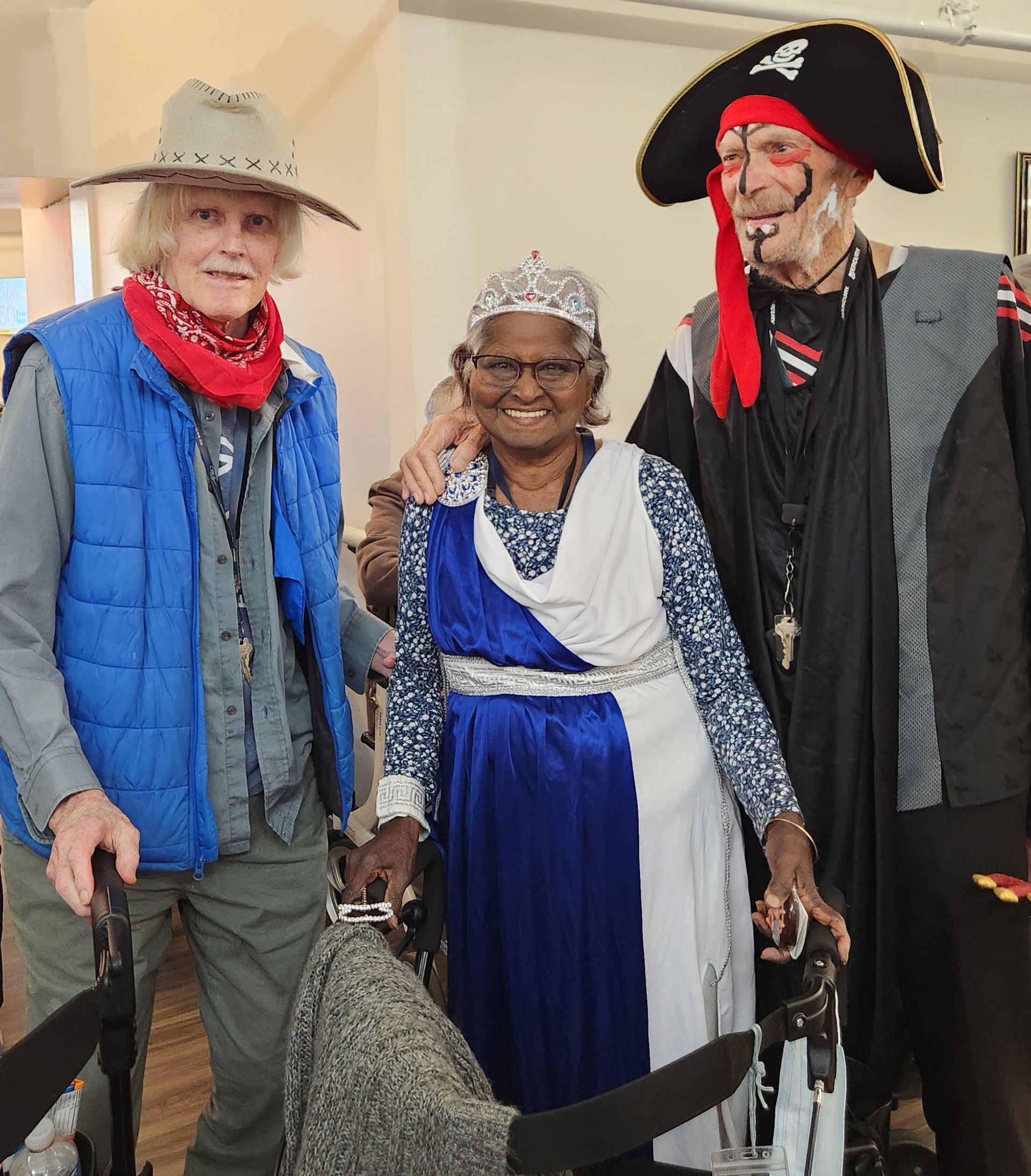 Three people dressed in pirate costumes are posing for a picture