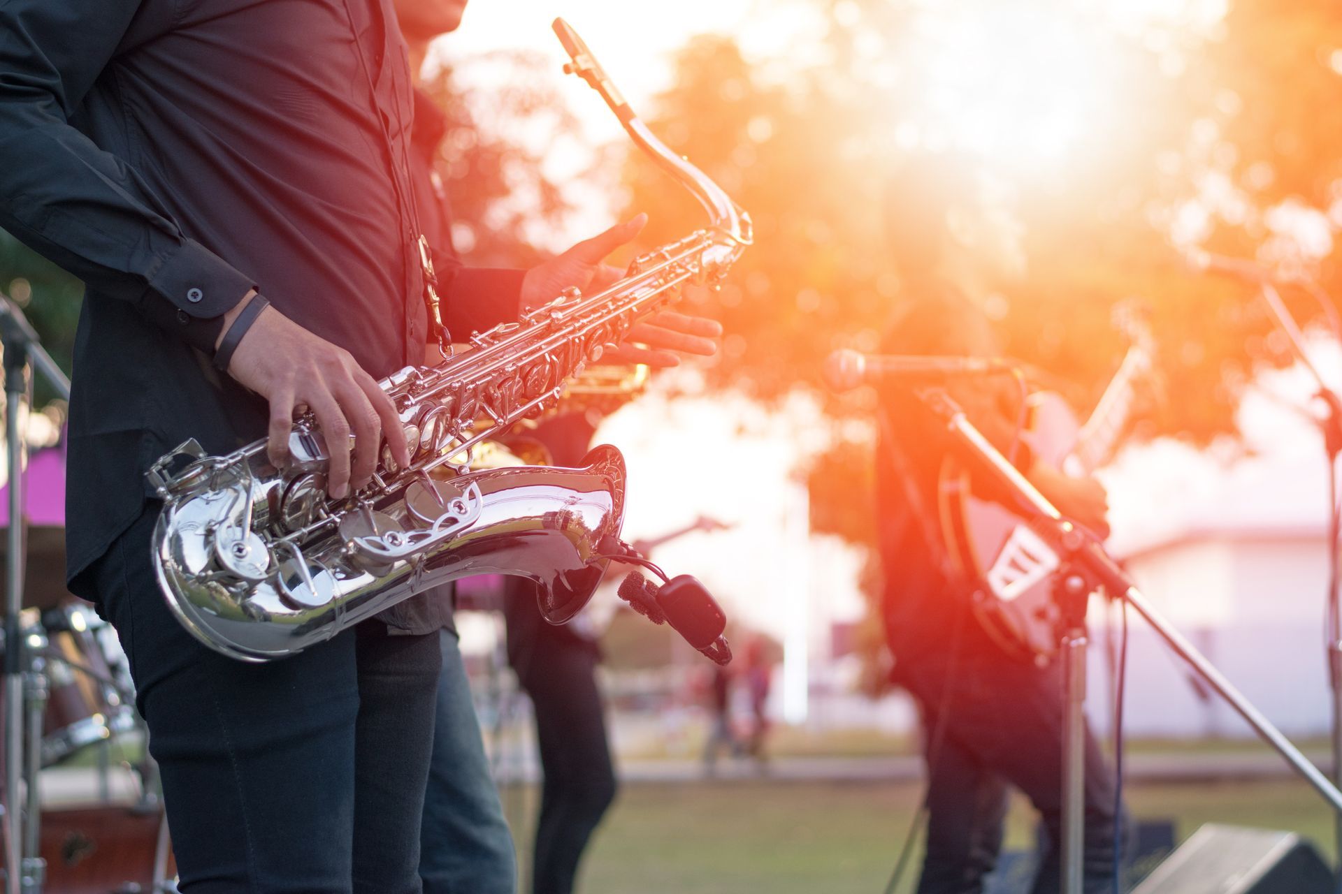 A man is playing a saxophone on a stage.