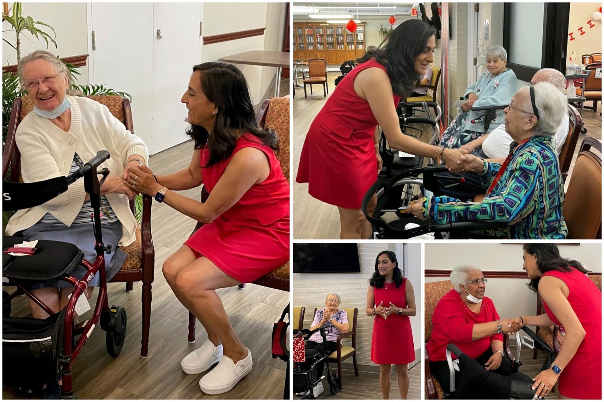 A woman in a red dress is holding the hand of an elderly woman in a nursing home.