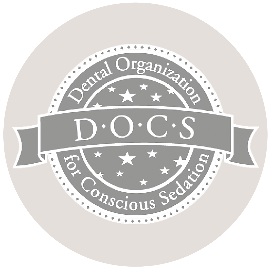 Gray circular logo for Dental Organization for Conscious Sedation with “DOCS” in the center