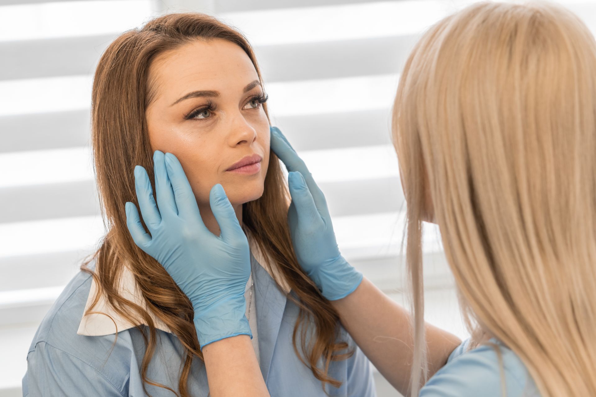 A woman is brushing her teeth in front of a mirror