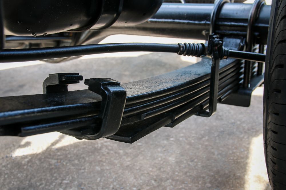 A Close up Of a Leaf Spring on A Car — Bonetig's Mobile Towbars & Trailers In Oak Flats, NSW
