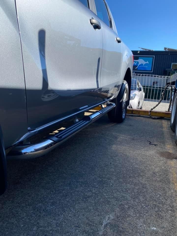 A Silver Truck with Chrome Side Steps Is Parked in A Parking Lot — Bonetig's Mobile Towbars & Trailers In Oak Flats, NSW

