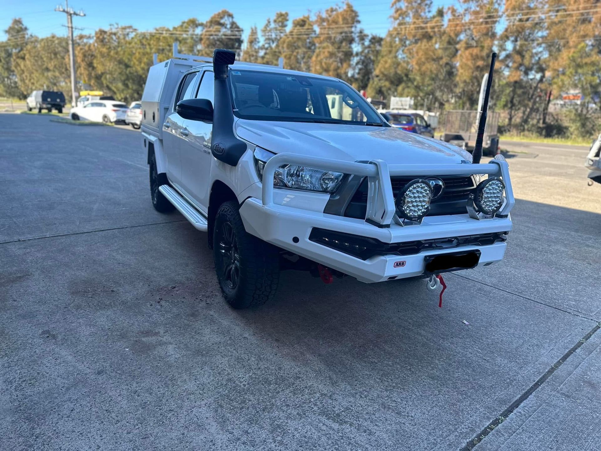 A White Ford Ranger with A Black Bumper Is Parked on The Side of The Road — Bonetig's Mobile Towbars & Trailers In Oak Flats, NSW
