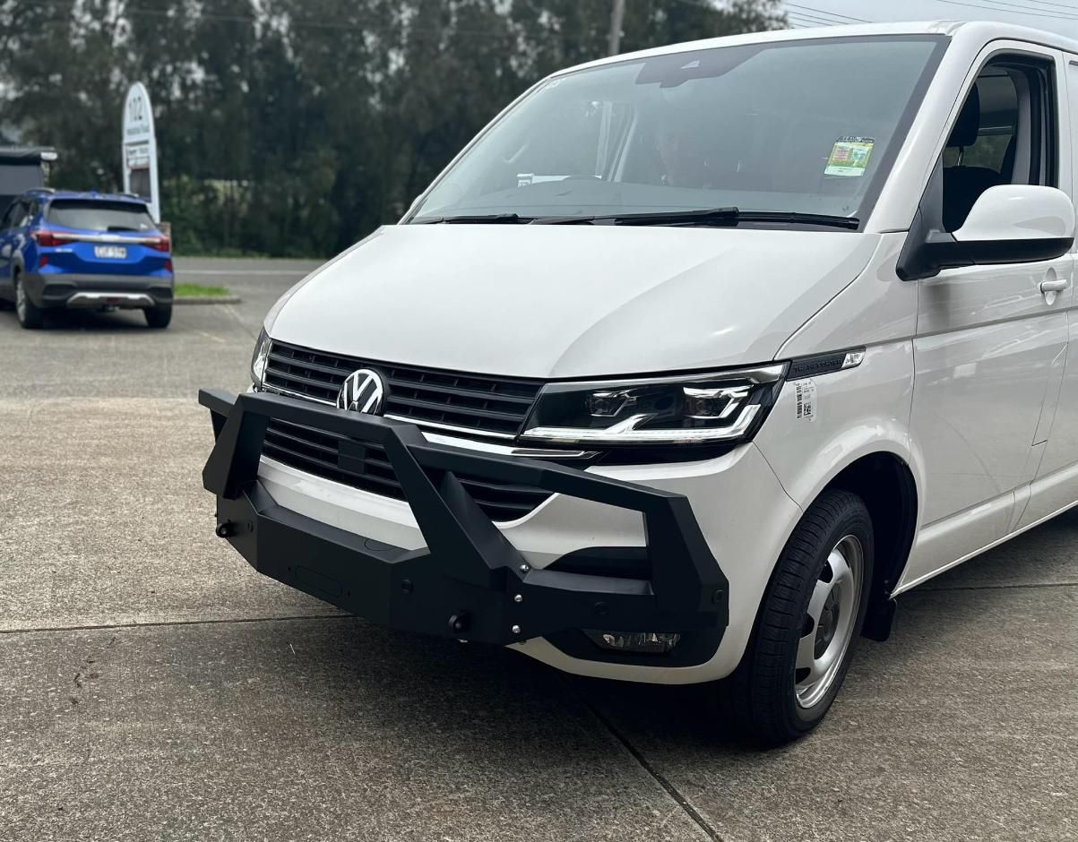 A White Van with A Black Bumper Is Parked on The Side of The Road — Bonetig's Mobile Towbars & Trailers In Oak Flats, NSW
