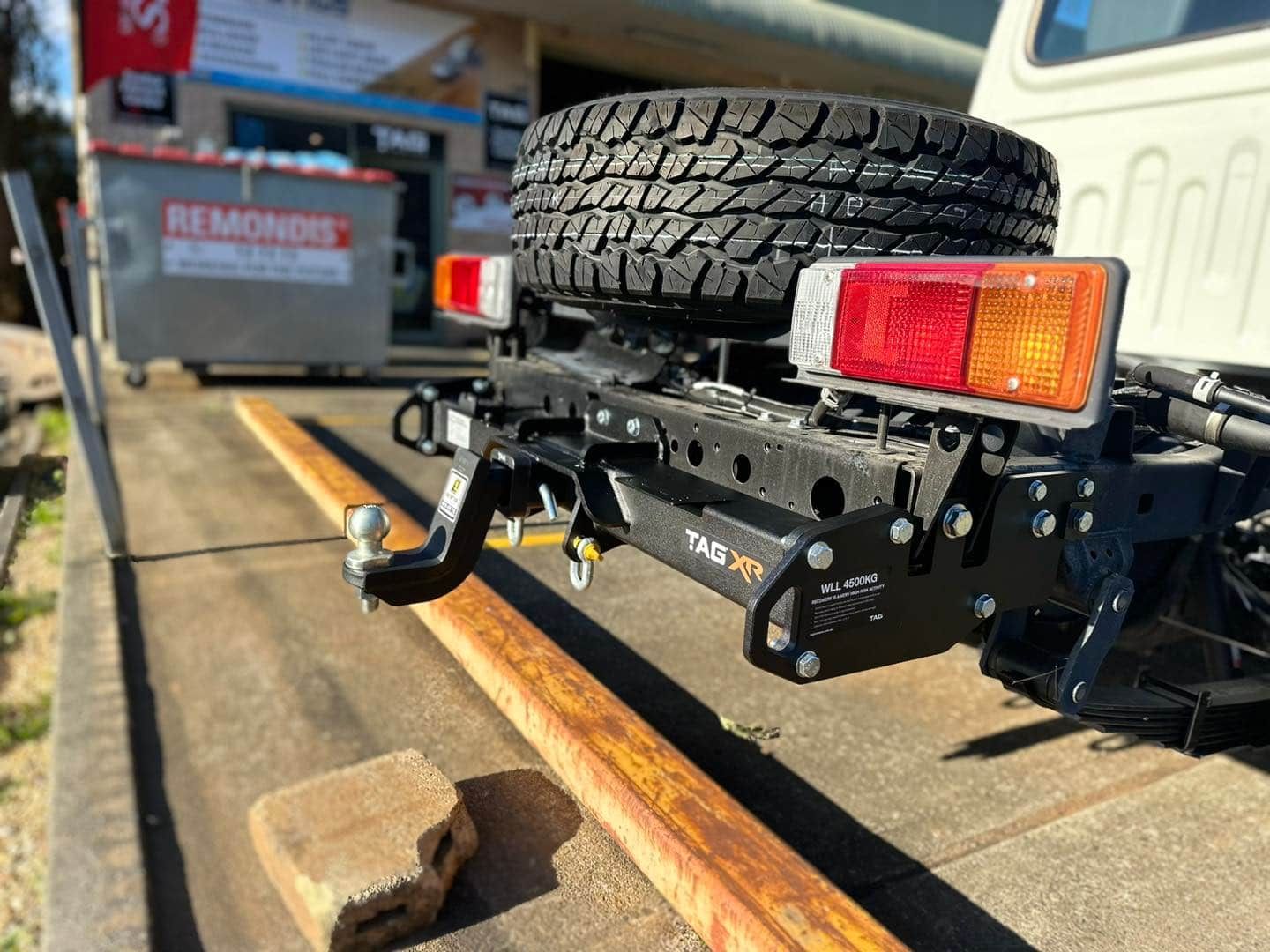 A Truck with A Trailer Attached to It Is Parked on The Side of The Road — Bonetig's Mobile Towbars & Trailers In Oak Flats, NSW