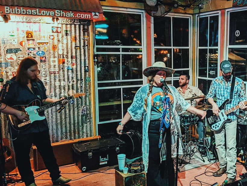 A group of people are playing instruments in a room.