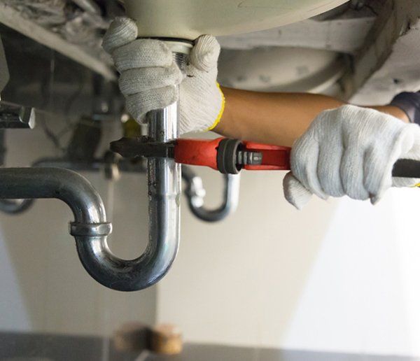 Plumber Doing Sink Pipe Repair — Albuquerque, NM — Donner Plumbing & Heating