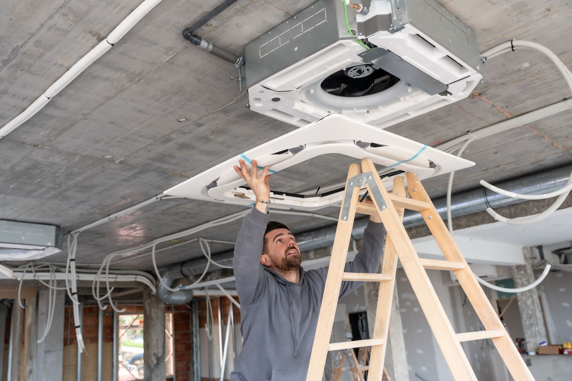 Local HVAC contractor servicing a residential air conditioning unit.