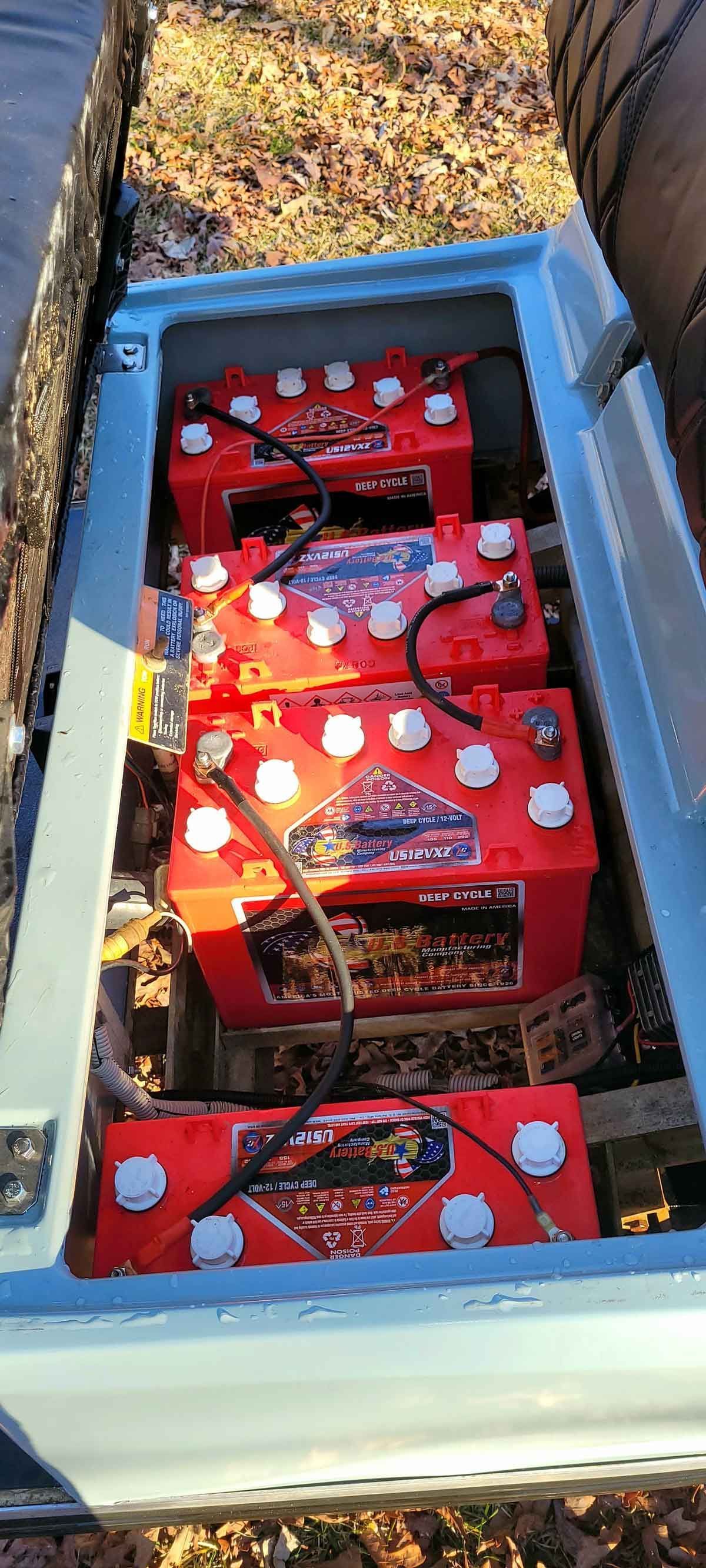 A bunch of batteries are sitting in the back of a truck.