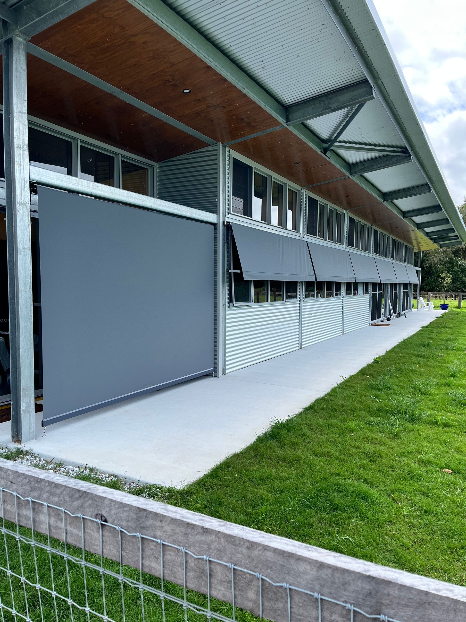 A Modern House With A Balcony And A Large Window With Blinds — Budget Home Improvements In Terranora, NSW