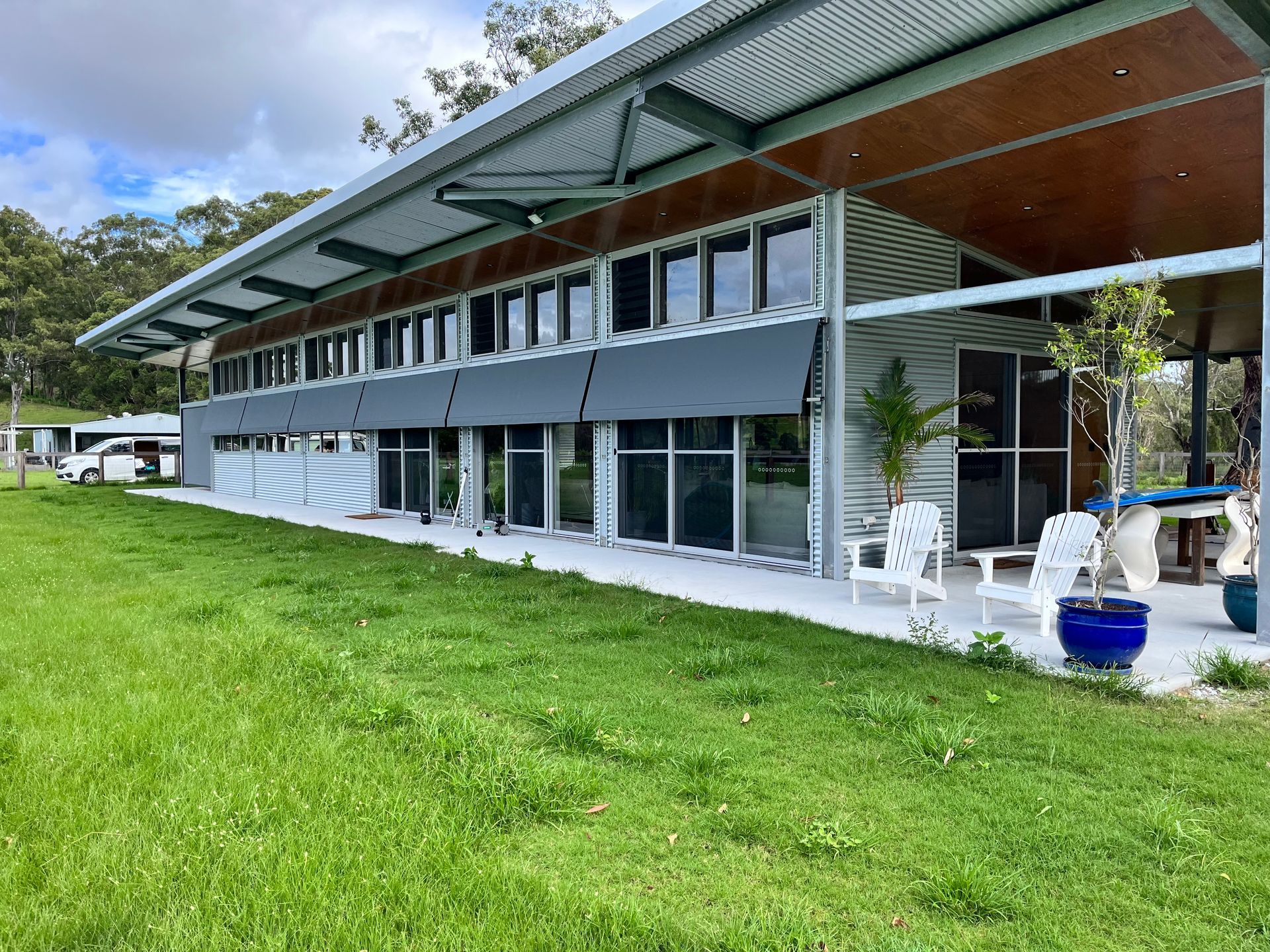 A White House With A Black Awning On The Side Of It — Budget Home Improvements In Tweed Heads South, NSW