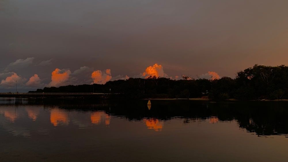 A Sunset Over A Lake With Trees — Budget Home Improvements In Pottsville, NSW