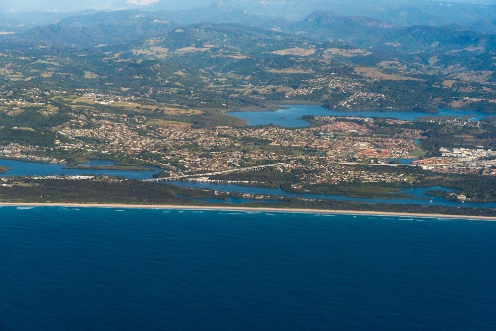 An Aerial View Of A City Surrounded By Water And Mountains — Budget Home Improvements In Terranora, NSW