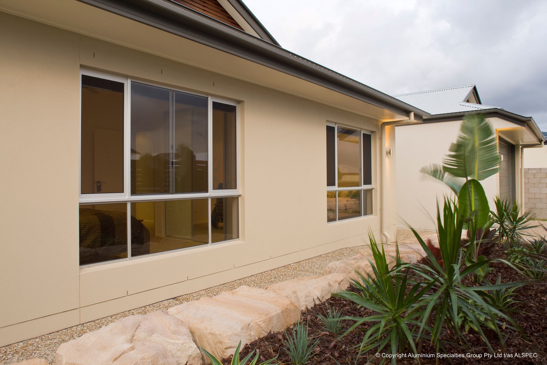 A Large Awning Is Hanging From The Side Of A Building — Budget Home Improvements In Pottsville, NSW
