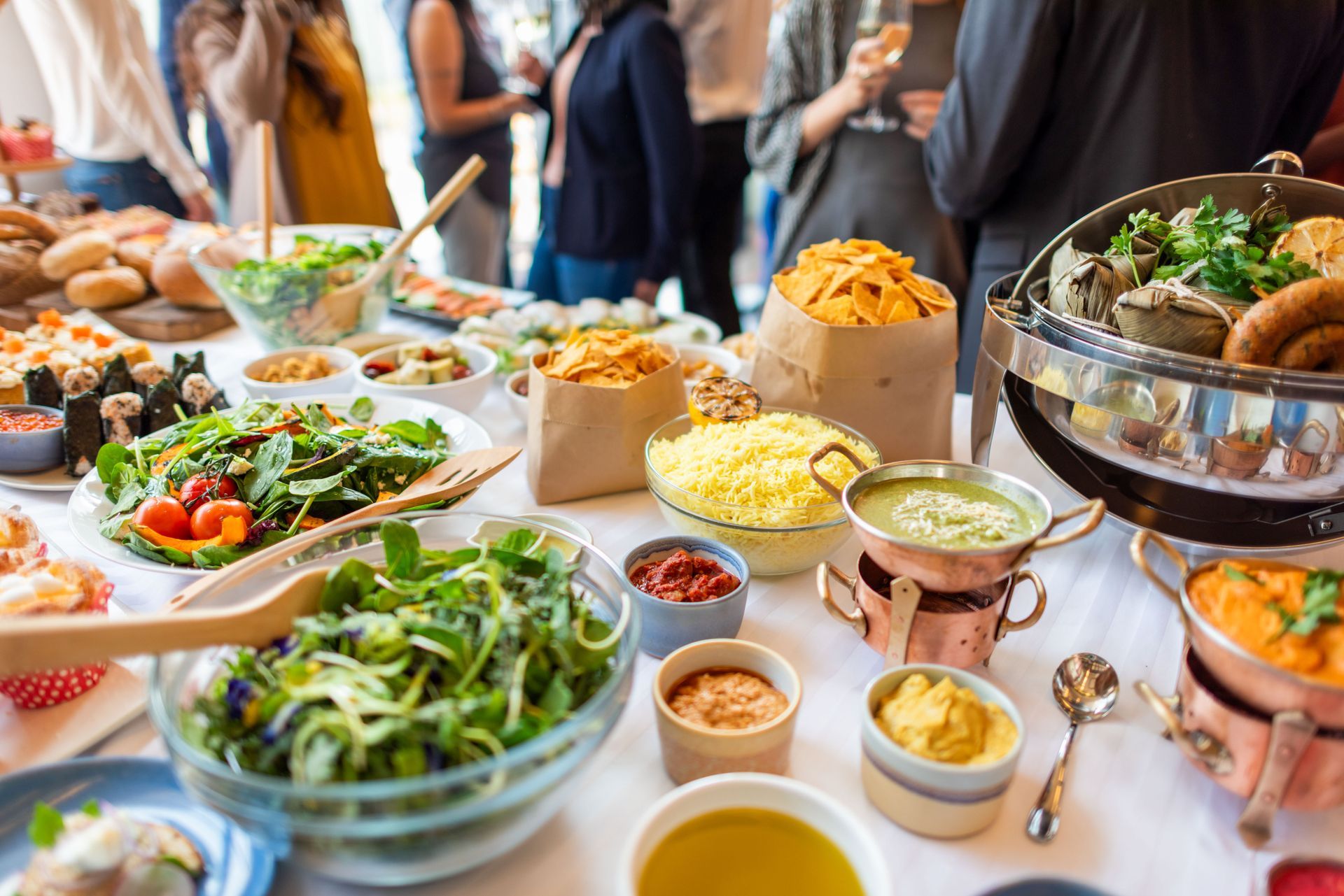 A buffet table displaying a variety of dishes, including salads, meats, and desserts
