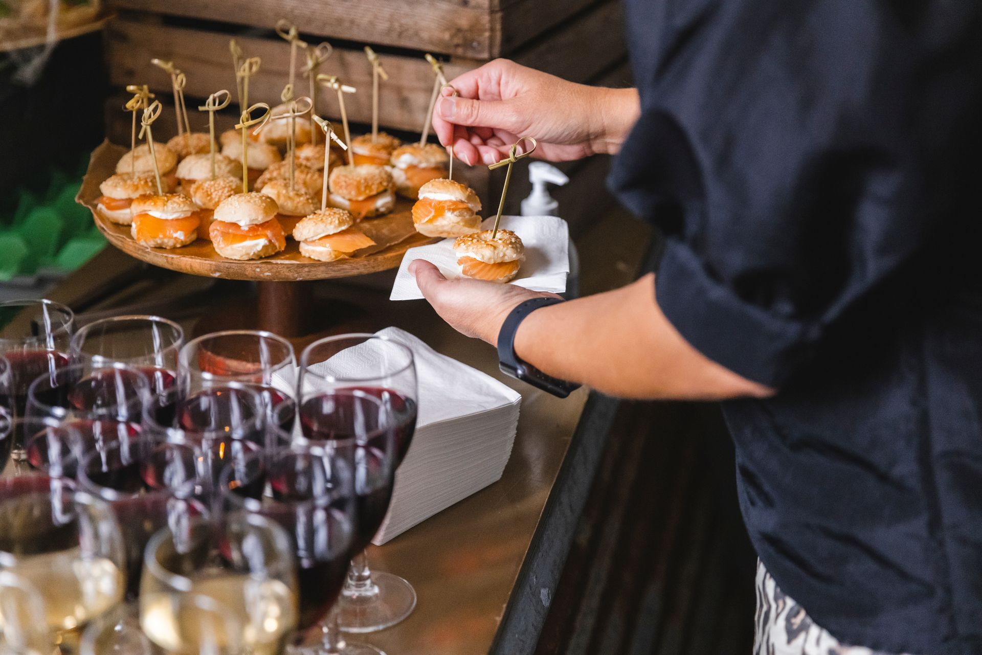 A close-up of a man serving appetisers on a napkin from a buffet