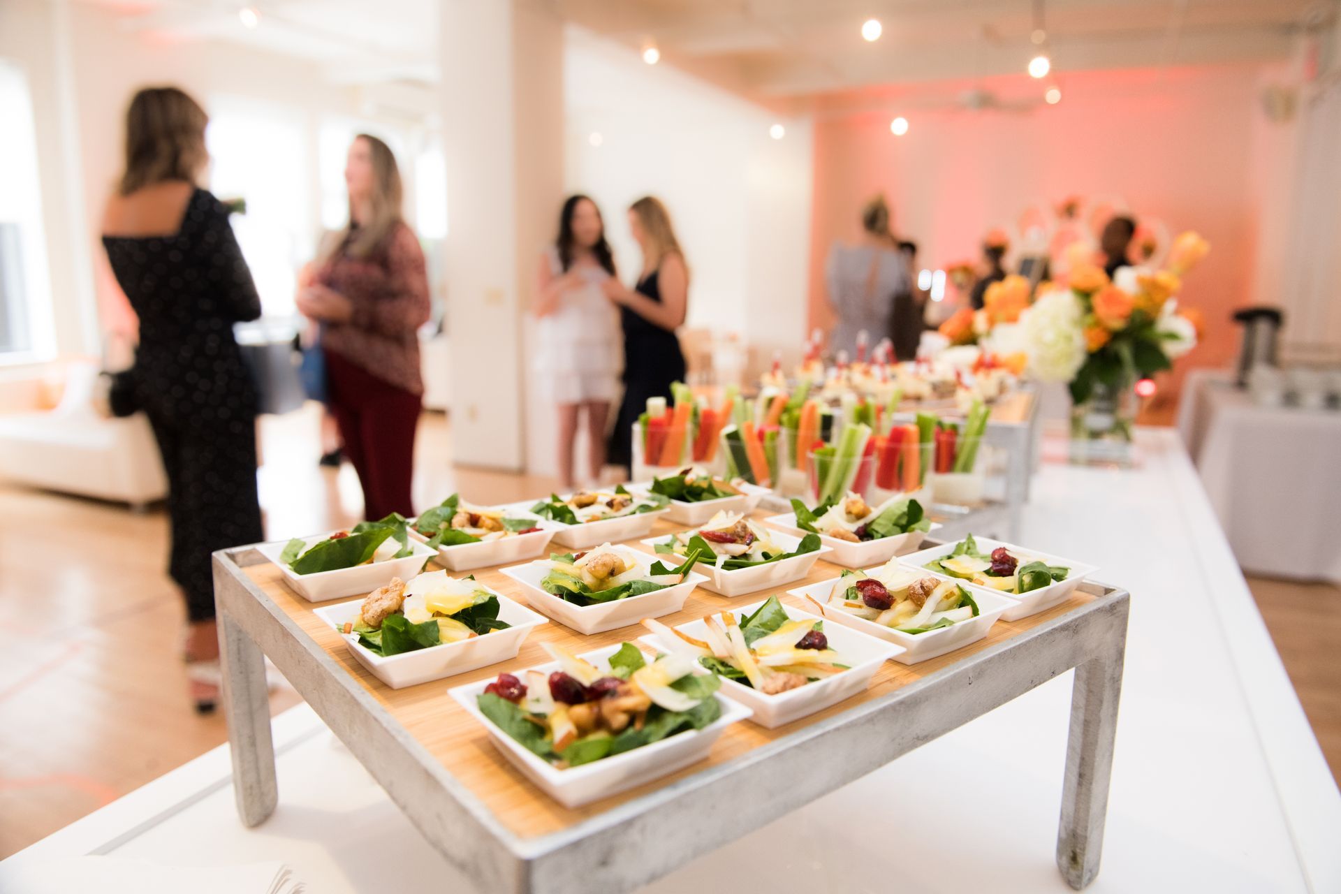 A catered event with a variety of small, fresh salad bowls.