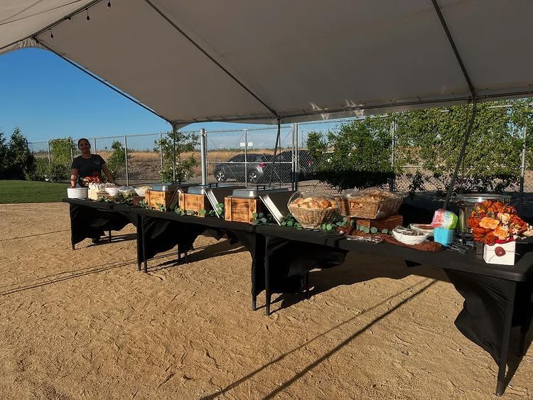 A long table with a lot of food on it in a room.