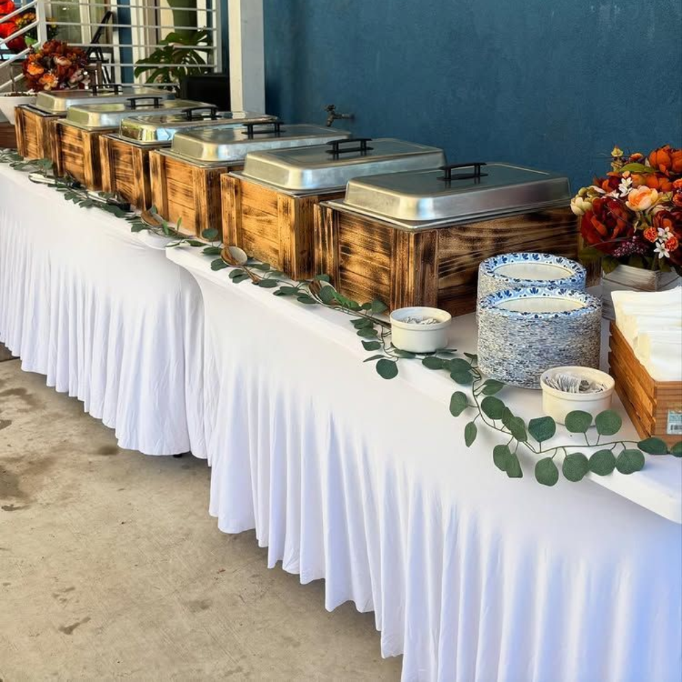 A buffet table with a variety of food on it.