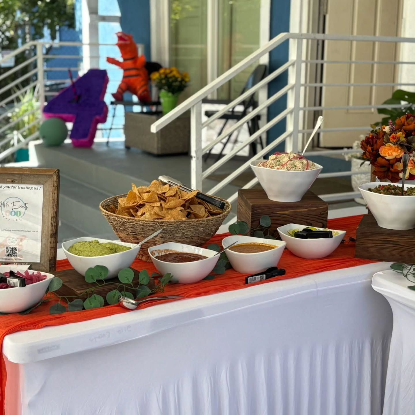 A long table with a lot of food on it in a room.