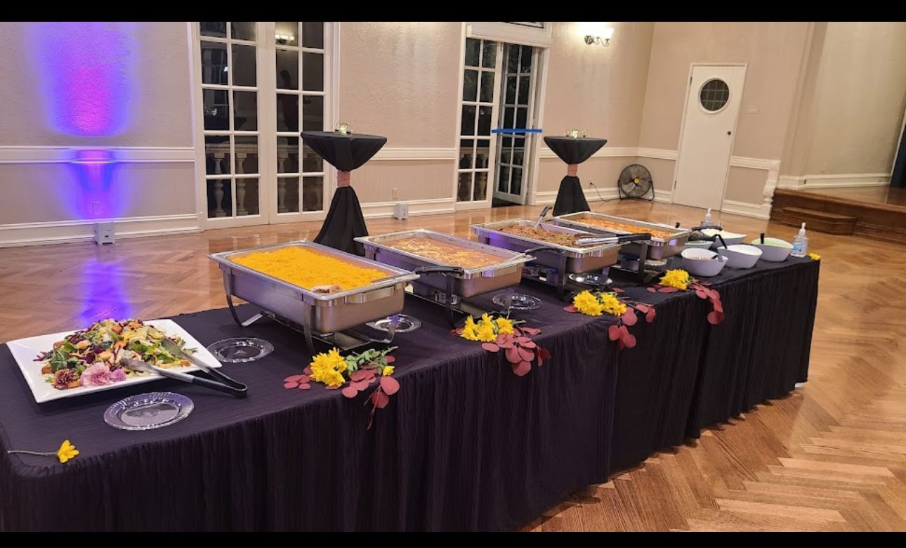 A long table with a lot of food on it in a room.